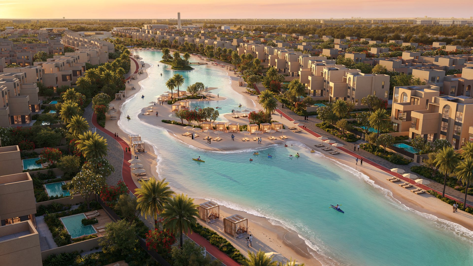 The lagoon winding between homes at golden hour, with beaches and shaded cabanas