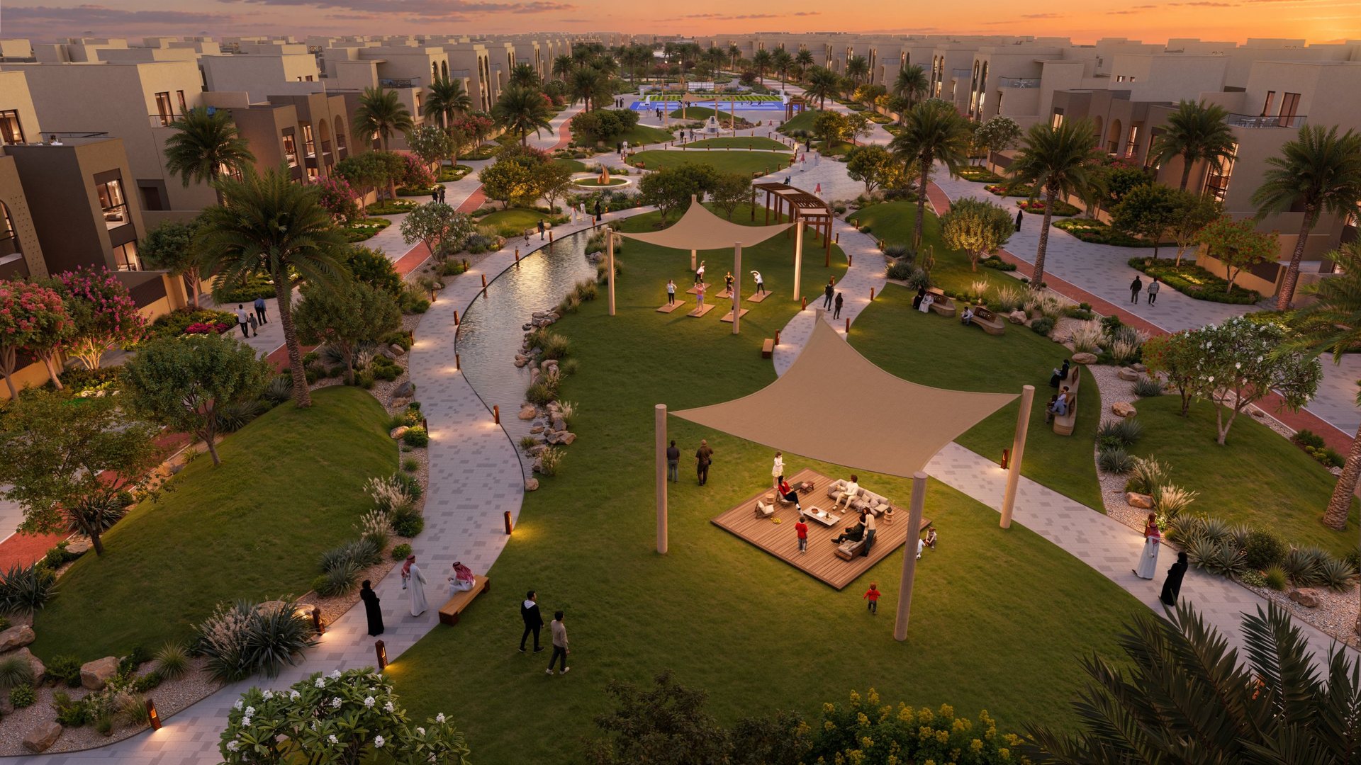 The central park at dusk: lawns under shade sails, a water channel and people doing yoga
